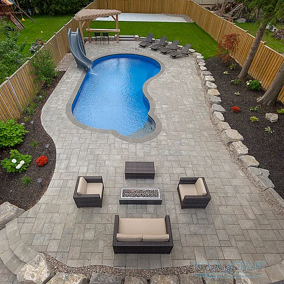 Freeform pool with an interlock deck and lounge area