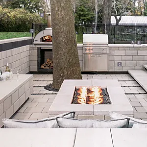 Outdoor kitchen with a pizza oven and fire table
